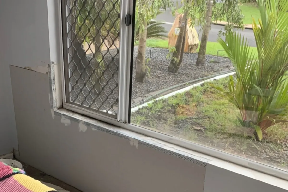 Wall section below a window being repaired in a St. Petersburg home
